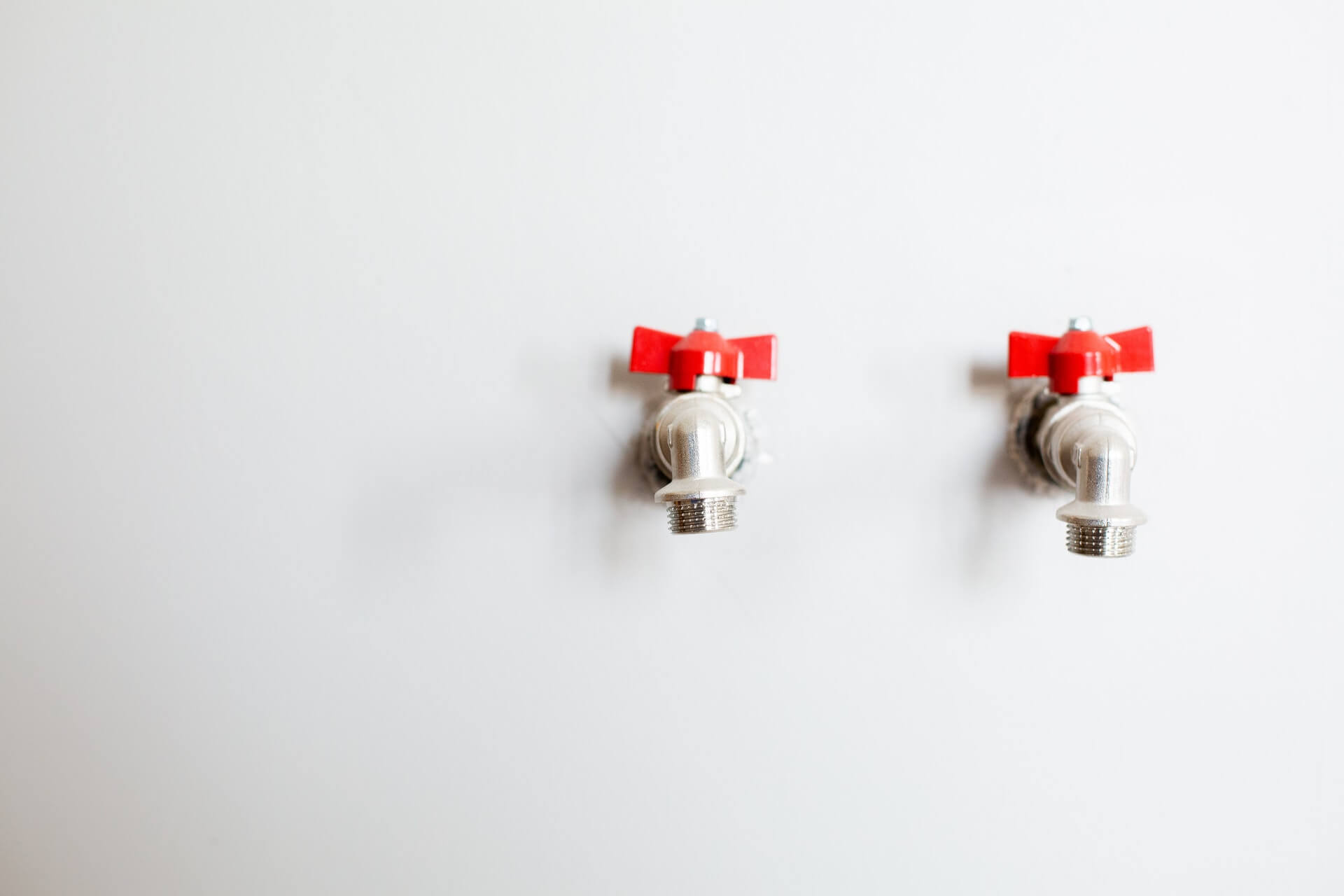 photo-of-faucets-on-white-wall-3616761